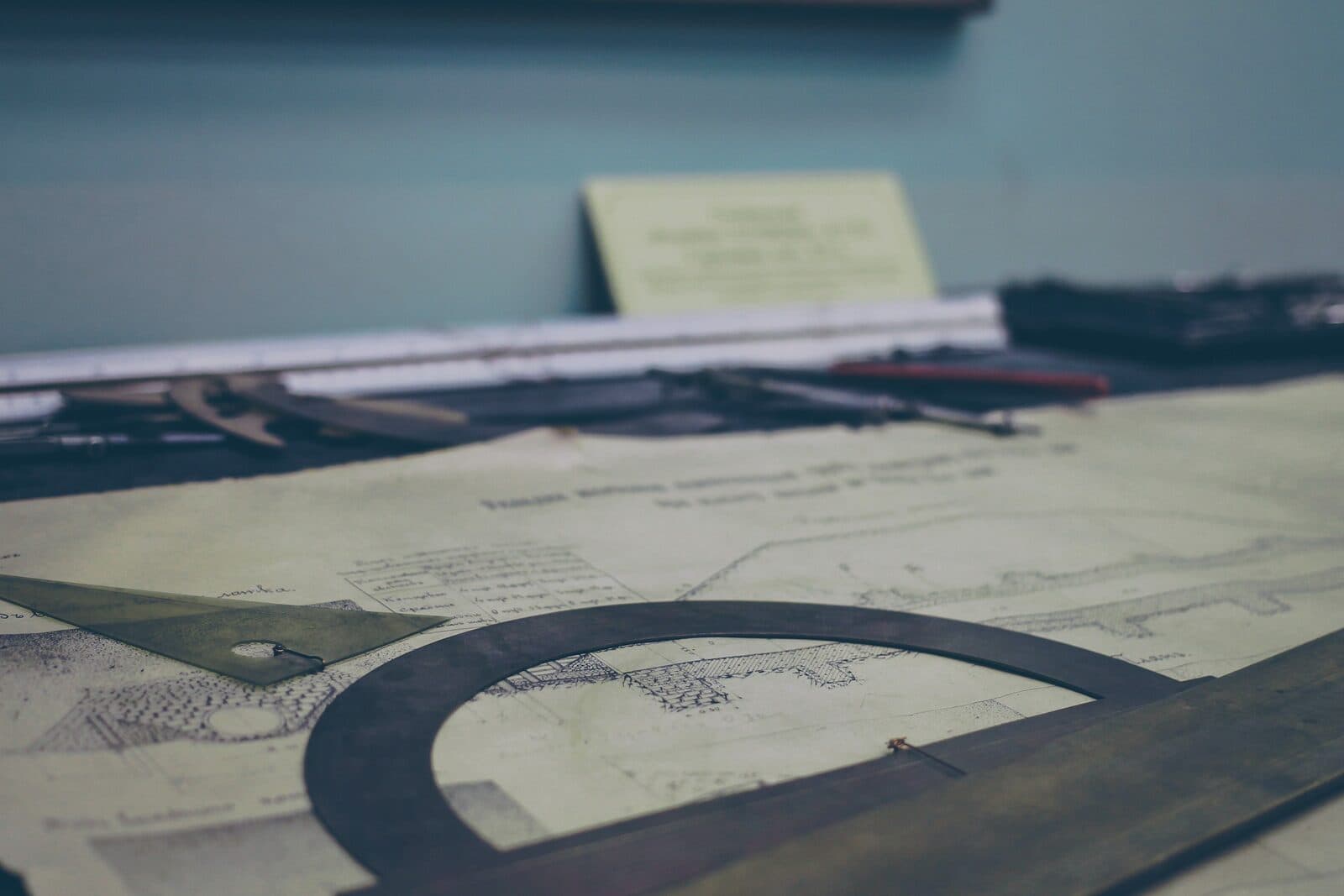 Architectural drawings spread across a dark table
