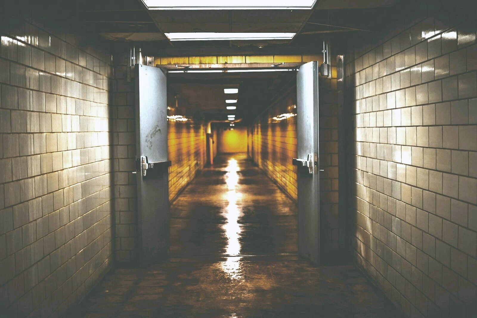 A long hospital corridor receding into low light