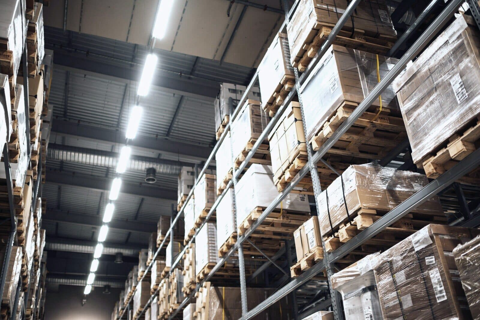 Racking stacked with cartons running down a warehouse aisle